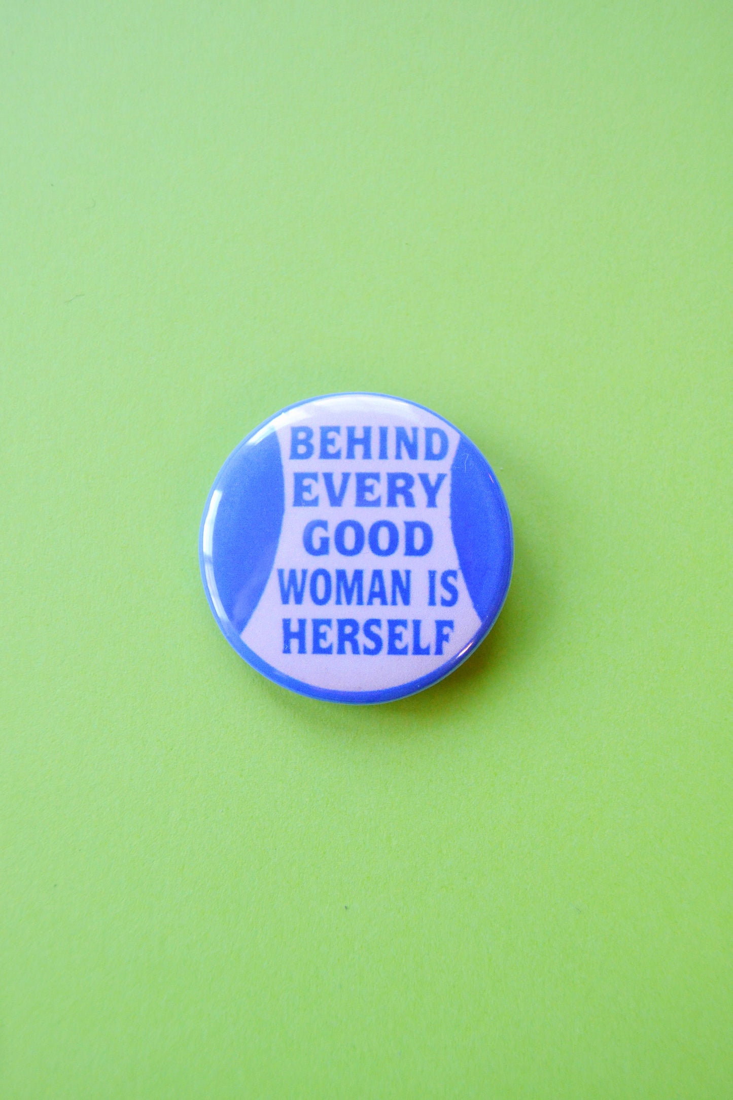 Behind Every Good Woman is Herself Reproduction Button